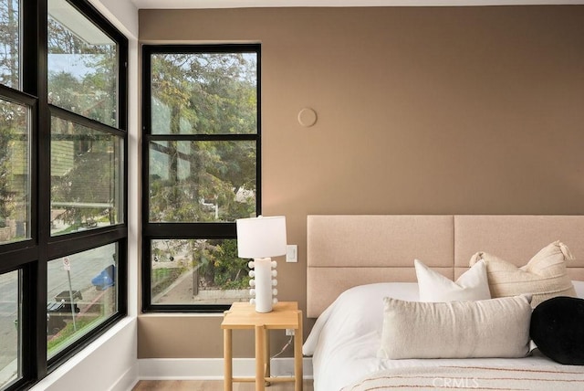 bedroom featuring baseboards and wood finished floors