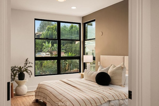 bedroom featuring recessed lighting, baseboards, and wood finished floors