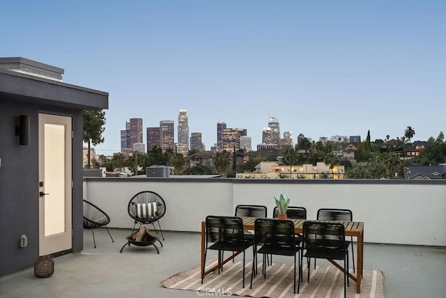 view of patio / terrace with a view of city and a balcony
