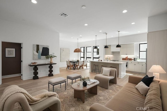 1315 W Cannon Dr, Los Angeles, CA 90026 - living room featuring light wood finished floors, baseboards, visible vents, and recessed lighting