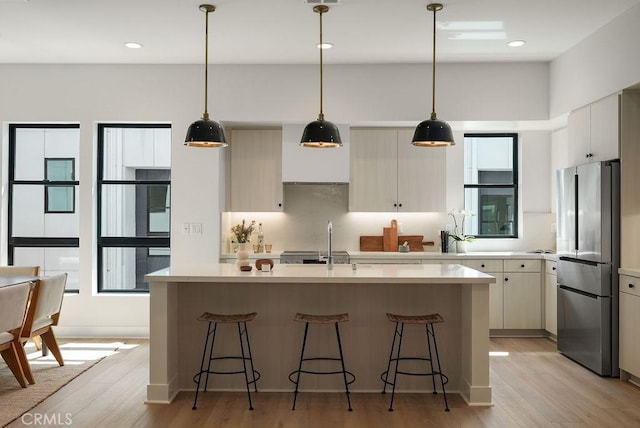 1315 W Cannon Dr, Los Angeles, CA 90026 - kitchen featuring a sink, light countertops, freestanding refrigerator, and a breakfast bar