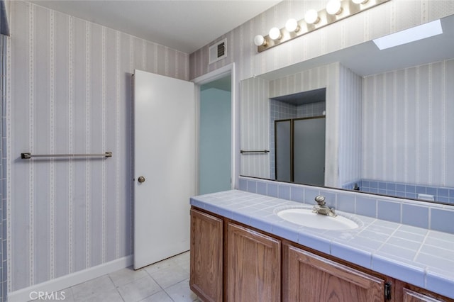 4837 N Hulbert Ave, Fresno, CA 93705 - bathroom featuring vanity, wallpapered walls, tile patterned flooring, and a shower with door