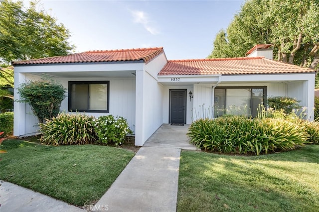 4837 N Hulbert Ave, Fresno, CA 93705 - mediterranean / spanish home featuring a tiled roof and a front yard