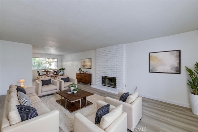 4837 N Hulbert Ave, Fresno, CA 93705 - living area with light wood-type flooring and a brick fireplace