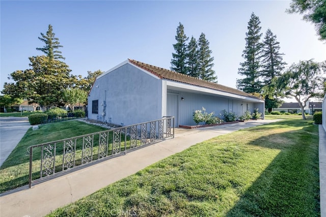 4837 N Hulbert Ave, Fresno, CA 93705 - view of side of property with a yard and a tiled roof