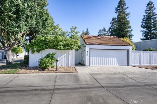 4837 N Hulbert Ave, Fresno, CA 93705 - view of front facade featuring a garage and a tiled roof