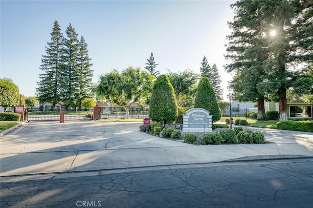 4837 N Hulbert Ave, Fresno, CA 93705 - view of concrete street with a gate, a gated entry, and traffic signs
