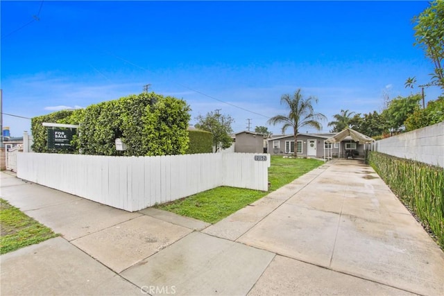 12152 Rosecrans Ave, Norwalk, CA 90650 - fenced yard featuring concrete driveway