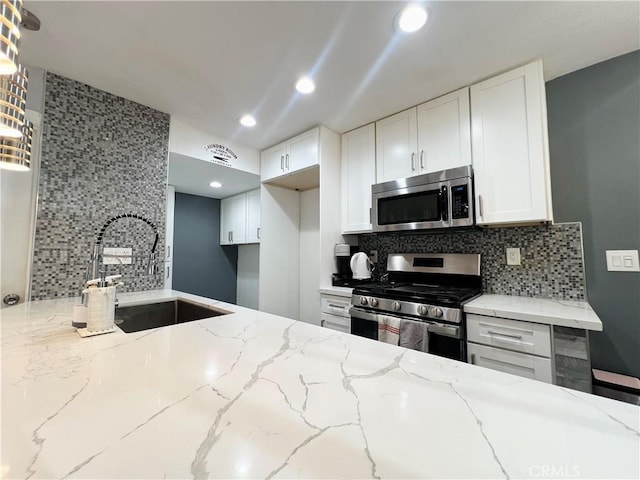 17760 Palo Verde Ave Unit 27, Cerritos, CA 90703 - kitchen featuring a sink, light stone countertops, tasteful backsplash, and stainless steel appliances
