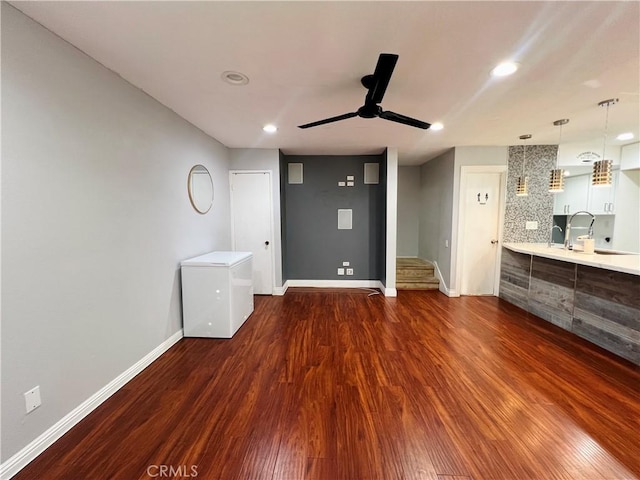 17760 Palo Verde Ave Unit 27, Cerritos, CA 90703 - unfurnished living room with dark wood-type flooring, ceiling fan, baseboards, and a sink