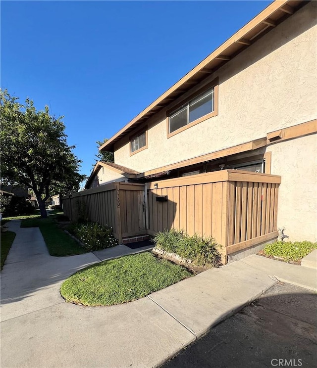 17760 Palo Verde Ave Unit 27, Cerritos, CA 90703 - view of side of property with stucco siding and fence