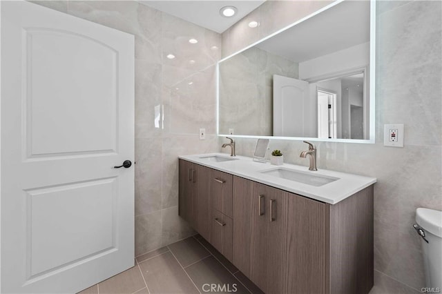 23625 Summit Dr, Calabasas, CA 91302 - full bathroom featuring double vanity, tile walls, toilet, and a sink