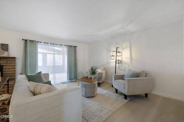 living room with baseboards and light wood-type flooring