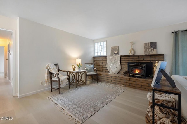 sitting room with baseboards and wood finished floors