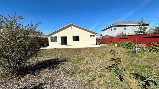 2428 Freestone Dr, Merced, CA 95340 - back of property featuring a patio and stucco siding