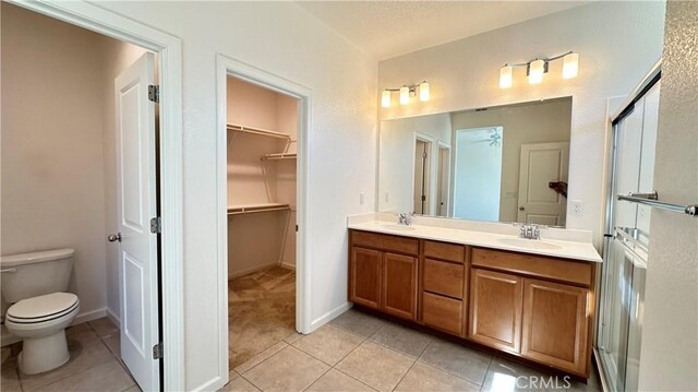 2428 Freestone Dr, Merced, CA 95340 - full bath with double vanity, tile patterned flooring, and a spacious closet