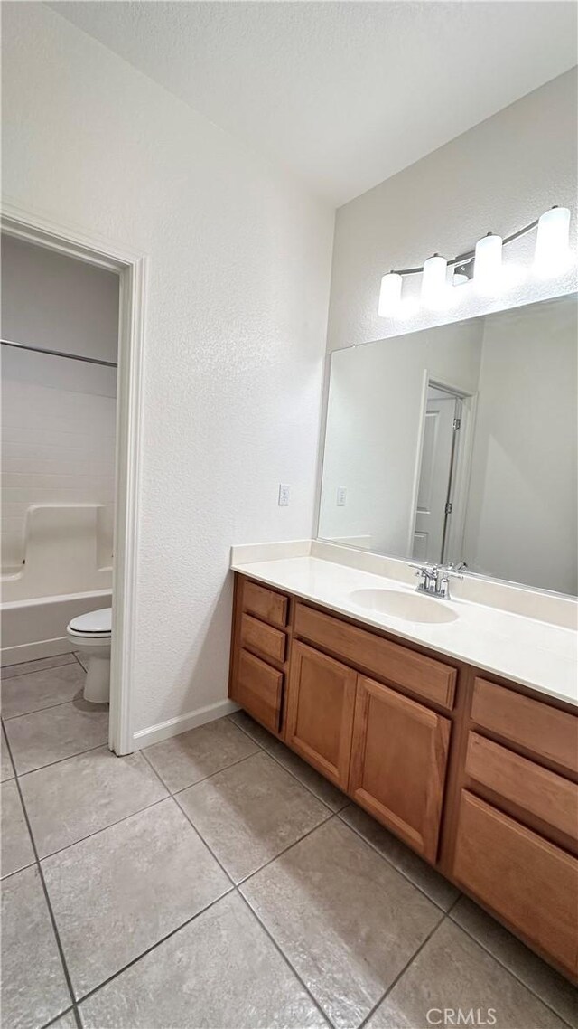 2428 Freestone Dr, Merced, CA 95340 - full bath with vanity, tile patterned floors, a textured wall, and washtub / shower combination