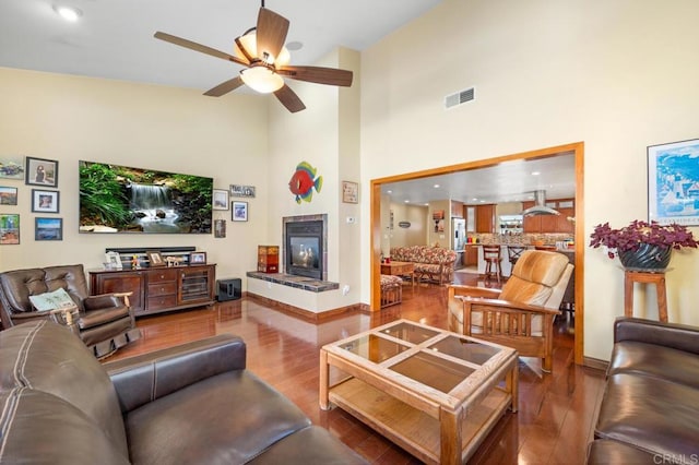 2722 Penkea Dr, Oceanside, CA 92054 - living area featuring ceiling fan, wood finished floors, a towering ceiling, a tile fireplace, and baseboards
