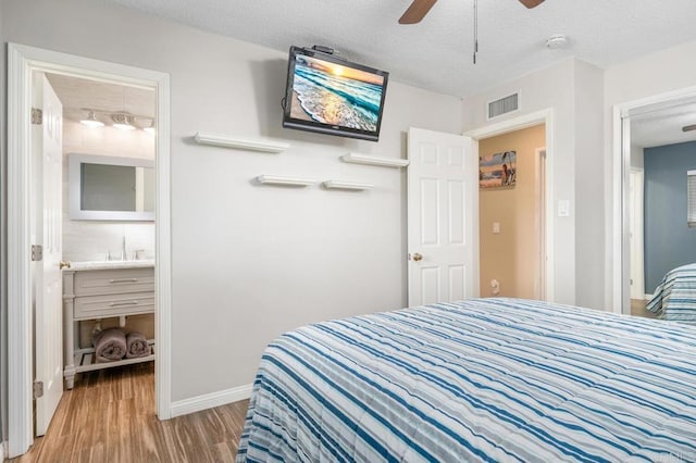2722 Penkea Dr, Oceanside, CA 92054 - bedroom with light wood-style floors, a textured ceiling, a sink, baseboards, and a ceiling fan