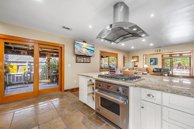 2722 Penkea Dr, Oceanside, CA 92054 - kitchen featuring stainless steel appliances, island range hood, baseboards, white cabinets, and light stone countertops