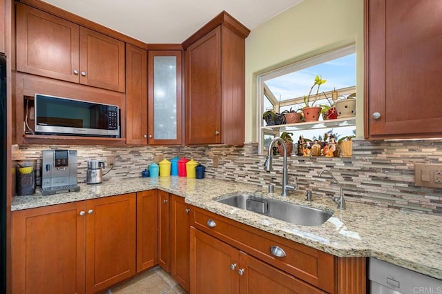 2722 Penkea Dr, Oceanside, CA 92054 - kitchen with stainless steel appliances, a sink, tasteful backsplash, and brown cabinets