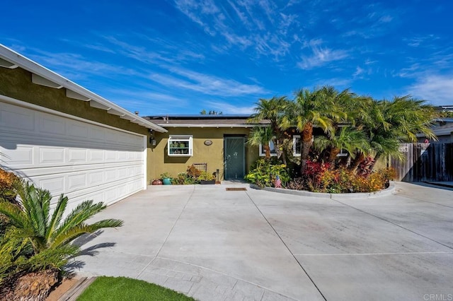 2722 Penkea Dr, Oceanside, CA 92054 - ranch-style house featuring concrete driveway, stucco siding, roof mounted solar panels, and a garage