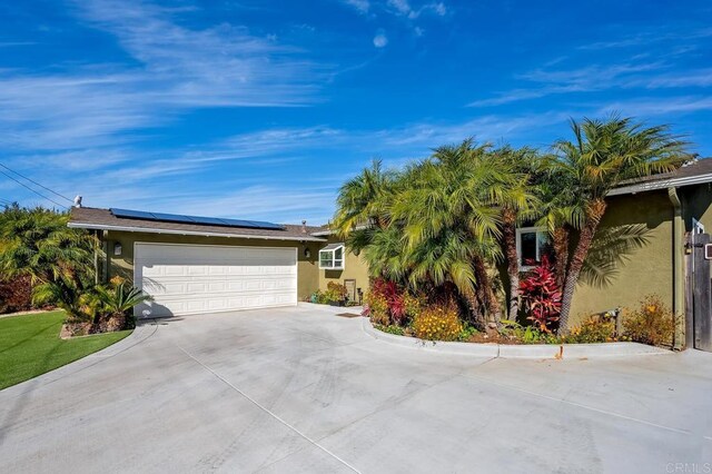 2722 Penkea Dr, Oceanside, CA 92054 - ranch-style home with driveway, solar panels, stucco siding, and an attached garage