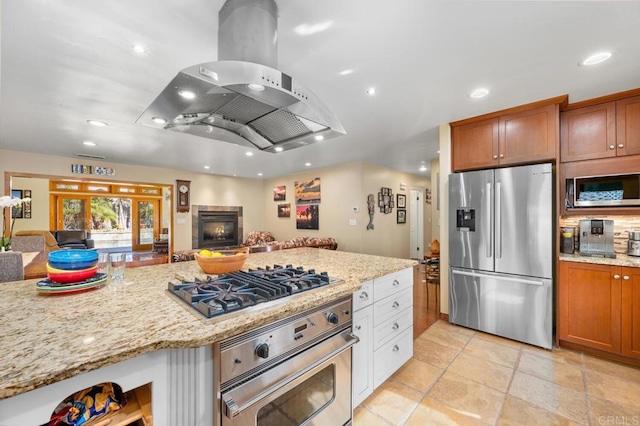 2722 Penkea Dr, Oceanside, CA 92054 - kitchen with stainless steel appliances, open floor plan, island exhaust hood, recessed lighting, and light stone counters