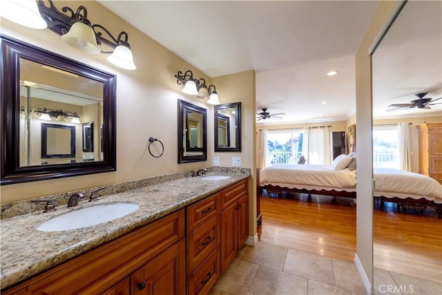 full bathroom with tile patterned flooring, a sink, a ceiling fan, and ensuite bath