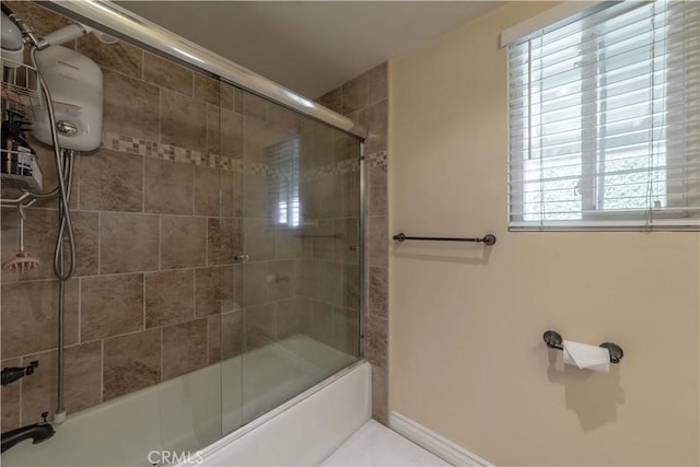 full bath with baseboards and combined bath / shower with glass door