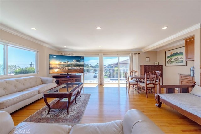 living area with crown molding, recessed lighting, and a wealth of natural light