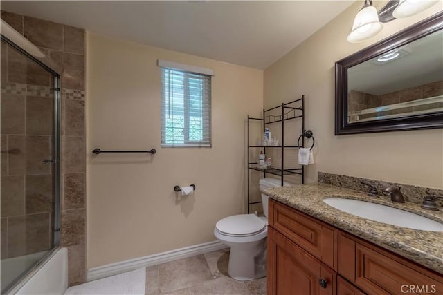 full bath featuring vanity, toilet, tile patterned floors, baseboards, and bath / shower combo with glass door