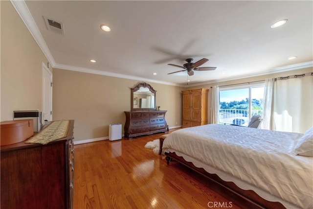 bedroom featuring visible vents, crown molding, baseboards, recessed lighting, and light wood finished floors