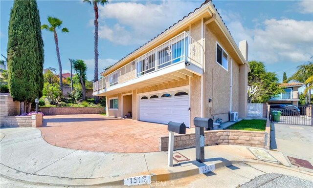 1516 W 5th St, San Pedro, CA 90732 - view of property with a garage, stucco siding, a balcony, and decorative driveway