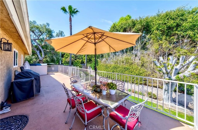 view of patio / terrace featuring outdoor dining space and a grill