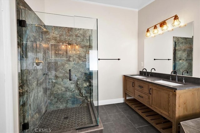 bathroom with a sink, a stall shower, tile patterned flooring, and crown molding