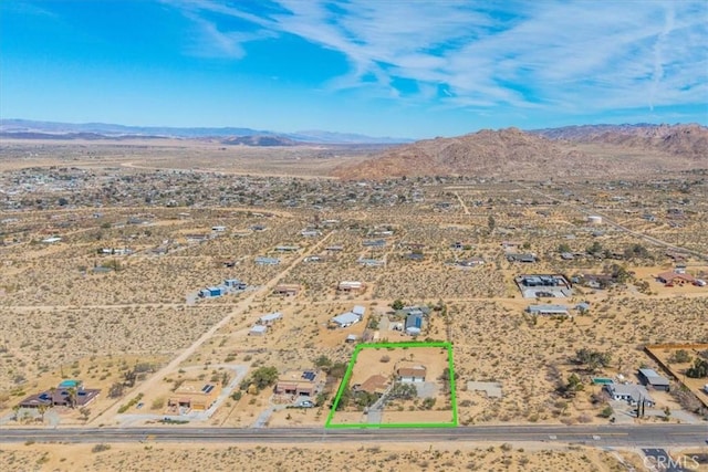 aerial view featuring a mountain view, a rural view, and view of desert