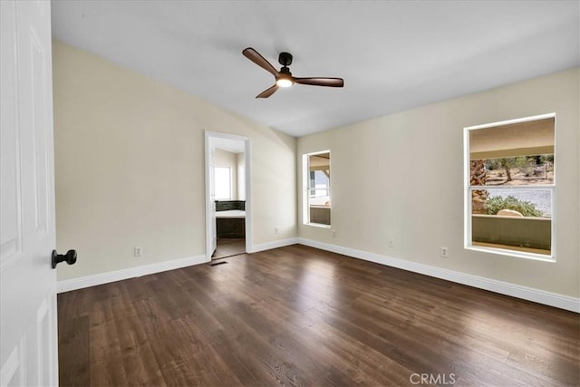 unfurnished room featuring plenty of natural light, lofted ceiling, ceiling fan, and wood finished floors