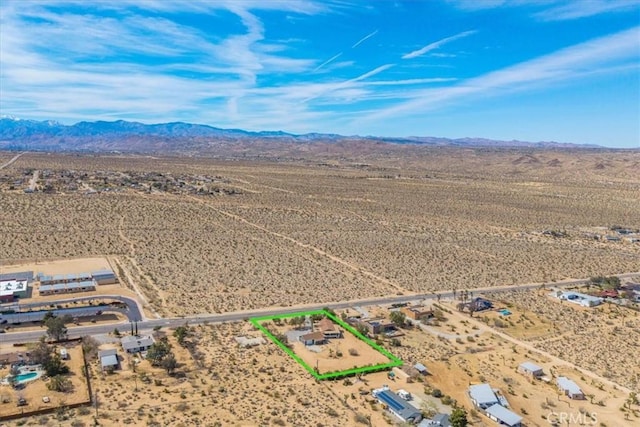 birds eye view of property with a rural view, a mountain view, and a desert view