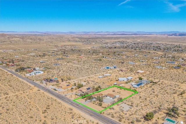 drone / aerial view with a desert view, a rural view, and a mountain view