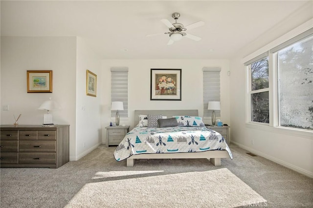 bedroom featuring ceiling fan, carpet floors, visible vents, and baseboards