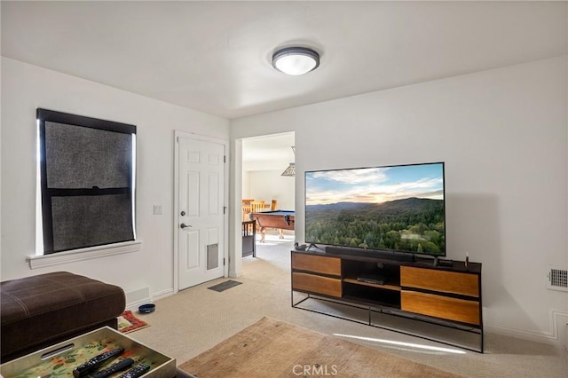 living area featuring baseboards and carpet