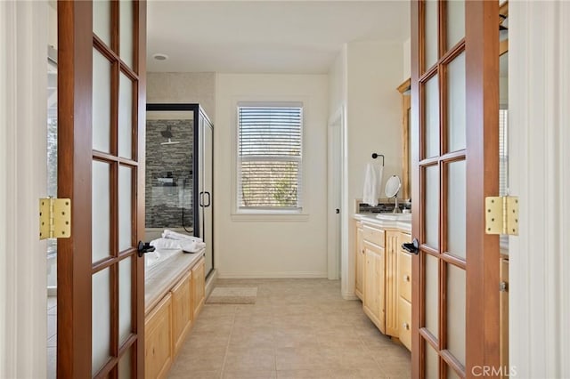 bathroom featuring a shower stall, tile patterned floors, and vanity