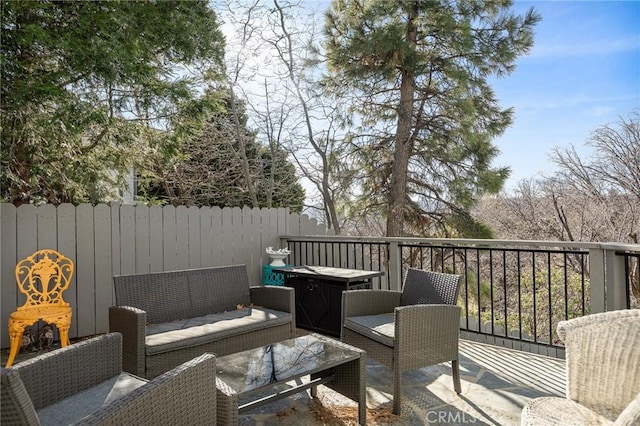 wooden terrace featuring fence and an outdoor hangout area