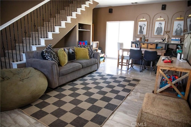 living room with stairs and visible vents