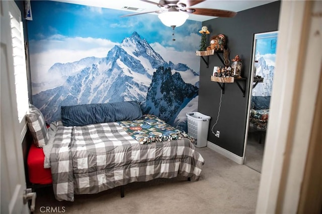 bedroom featuring carpet flooring, a ceiling fan, baseboards, and visible vents