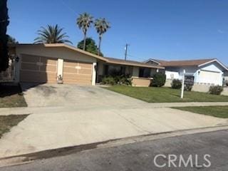 9394 Kempster Ave, Fontana, CA 92335 - view of front of home with concrete driveway, a garage, and a front lawn