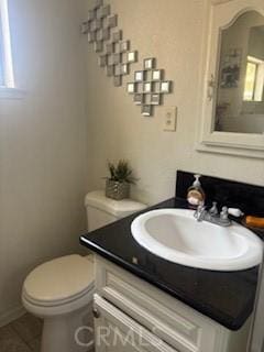 9394 Kempster Ave, Fontana, CA 92335 - bathroom featuring toilet, vanity, and baseboards