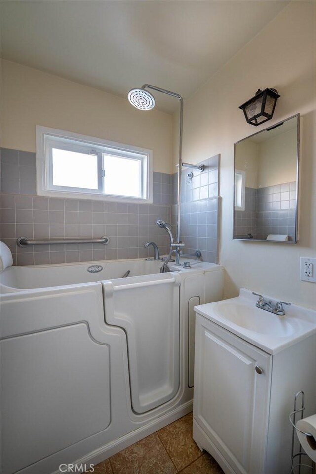 12821 Salisbury St, Baldwin Park, CA 91706 - bathroom featuring tile walls, a bath, and vanity