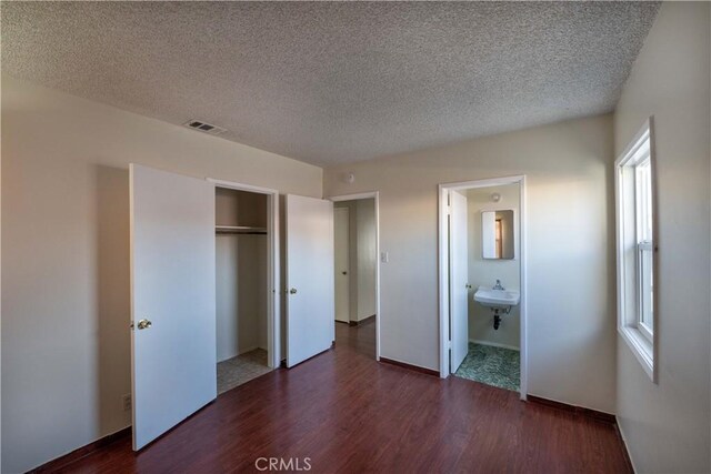 12821 Salisbury St, Baldwin Park, CA 91706 - unfurnished bedroom with a closet, dark wood-style flooring, and multiple windows